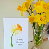 Happy Mother's Day single daffodil card next to bunch of daffodils